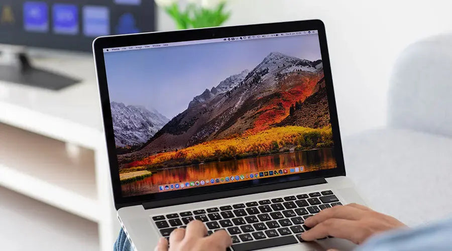 Customer reviewing MacBook Pro before buying at PayMore Thornton
