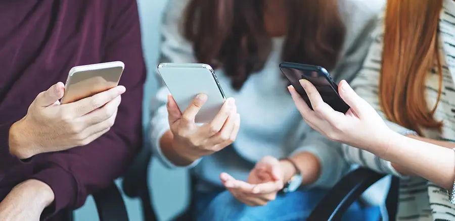 Customer reviewing Samsung and Google phones before buying at PayMore Thornton